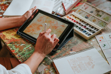 Close up of female artist or designer sketching on the digital tablet