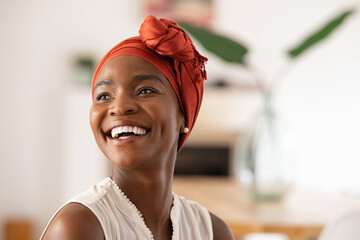 Joyful mature african woman laughing and looking away - Powered by Adobe
