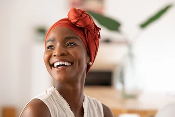 Tuinposter Joyful mature african woman laughing and looking away © Rido