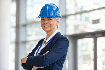 Portrait of mature architect with hardhat at construction site