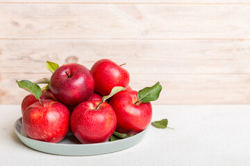 juicy red apples in a bowl or plate on the table top view. Copy space