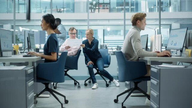 Diverse Team of Managers Working and Having Discussions in Modern Big City Office. Colleagues Work on New Business Opportunities, Evaluate Financial Reports, Plan Investment Strategy.
