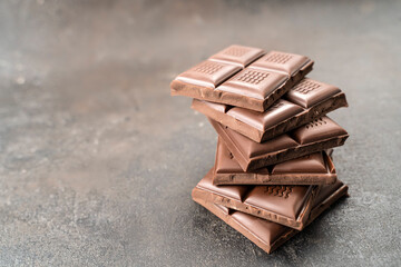 Sweet Chocolate tower pieces chocolates. Stack of chocolate pieces. Background with chocolate. recipe Cooking handmade chocolate bar, dessert, candies