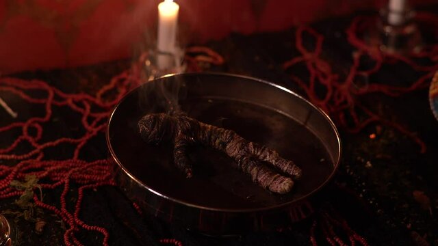 4K Cinematic horror scene. The rest of the puppet after the voodoo spell is done.