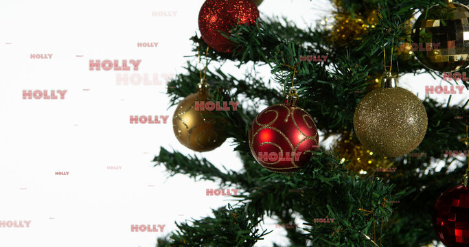 Image of holly text in repetition over christmas tree on white background