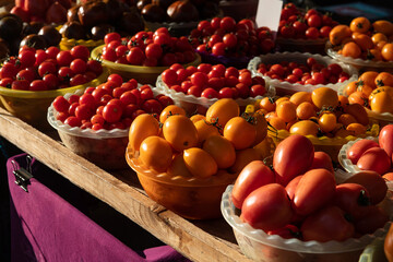 Market counter with different varieties of tomatoes, fresh and healty food, health care