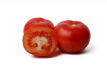 ripe red tomatoes lie isolated on a white background