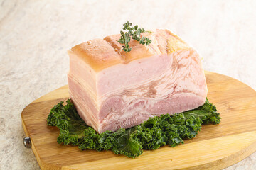 Cut of pork bacon over board