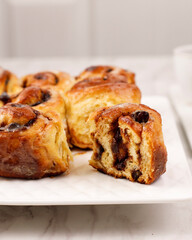 Sweets Cinnamon Roll with Cinnamon Powder, Half Cut. Serve on White Plate