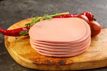 Sliced pork sausages stack over board