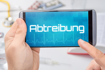 Smartphone mit dem Text Abtreibung auf dem Display
