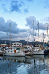 Obraz na płótnie Canvas Port de Pollenca marina with sailing boats sailboats on Mallorca travel traveling holidays vacation portrait format in Spain
