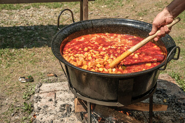 Romanian traditional food prepared at the cauldron on the open fire