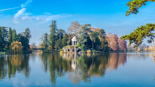 Vincennes, the temple of love and artificial grotto on the Daumesnil lake, in the public park, in autumn
