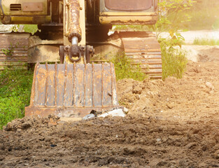 bucket of excavator on ground in construction site