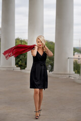 Beautiful Woman in a dress among the white columns of an architectural arch. Odessa. Ukraine.
