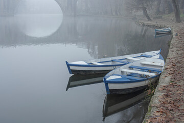 Fototapeta na wymiar Traditional river wooden boats in the fog
