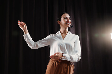 Motivational speaker with headset performing on stage