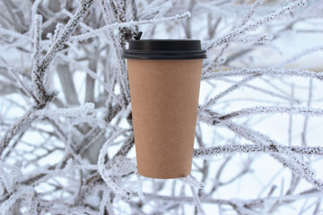 Takeaway coffee glass. Cup of coffee with place for text. Glass for coffee on a winter background.