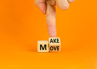 Make your move symbol. Businessman turns the wooden cube with words 'Make move'. Beautiful orange background. Make your move and business concept. Copy space.