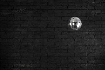 disco ball on black brick wall