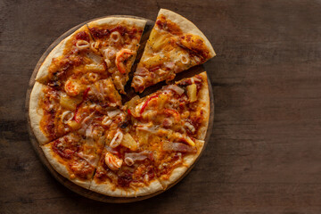 Pieces of pizza being separated from the tray.
