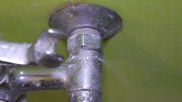 broken faucet,water flows from the faucet, the faucet is cracked