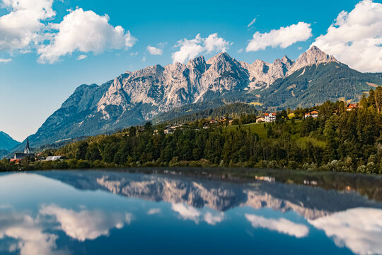 Beautiful alpine summer view with reflections on a car roof and the famous Tennengebirge mountains in the background near Pfarrwerfen, Salzburg, Austria