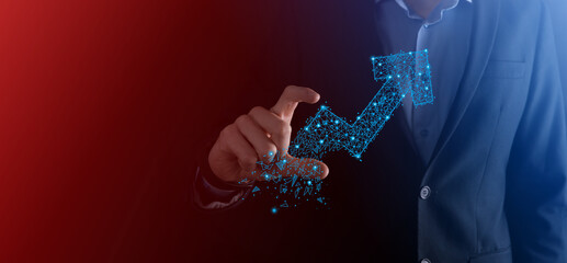 Businessman hold graph, arrow of positive growth icon.pointing at creative business chart with upward arrows.Financial, business growth concept.Low polygonal.increased sales, or increased value