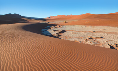 Fototapeta na wymiar Big orange sand dune with blue sky - Sossusvlei, Namib desert, Namibia, Southern Africa