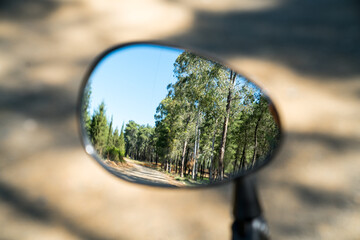 Rear view from bike mirror. Sport and active life concept in spring and summer.