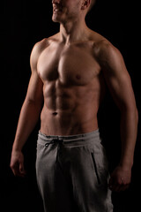 Man Showing ABS. Muscle man Posing. Strong Body Concept. Topless Sport man Bodybuilder. Six Pack Spotsman Smilling