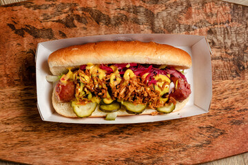 fast food hot dog with homemade sausage, deep-fried onions and pickled cucumbers