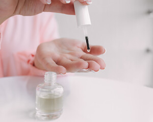 Woman used oil to hydrate her skin.   Woman's hand dripping oil. Moisturizing oil is dropping on hand's skin from pipette.