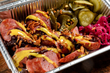 fried homemade sausages with sauce and pickled vegetables.