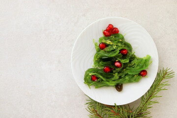 Traditional Japanese wakame salad with sesam seeds shaped like a christmas tree selective focus.