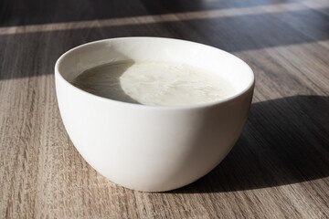 Kefir grainsin a white bowl on a wooden table