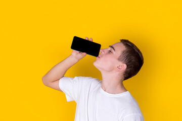 A handsome guy in a white t-shirt gesticulating on  a yellow background