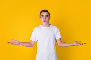 A handsome guy in a white t-shirt on a yellow background