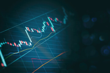 Close up financial chart with uptrend line graph in stock market on defocused blue color bokeh background