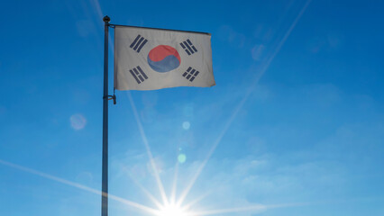 Flag of South Korea against the blue sky with sun rays. Diplomacy concept. International relations.