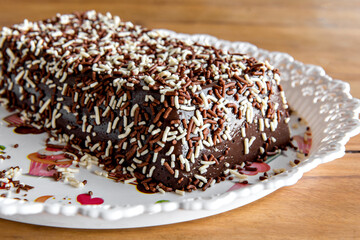 Chocolate pudding with sprinkles, delicious chocolate dessert on wooden table