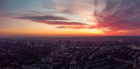 Aerial scenic vivid colorful sunset view with epic skyscape. Kharkiv city center panorama, Pavlove pole residential district streets in evening light