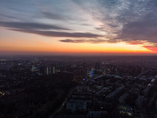 Aerial scenic vivid colorful sunset view with epic skyscape. Kharkiv city center, recreation park Sarzhyn Yar, Pavlove pole residential district streets in evening light