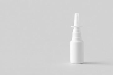 Nasal spray mockup. White plastic bottle with blank label.