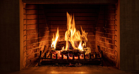 Christmas time, cozy fireplace. Wood logs burning, fire bricks background, relaxation and warm home - Powered by Adobe