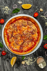 Fresh pizza with a ton on wood background