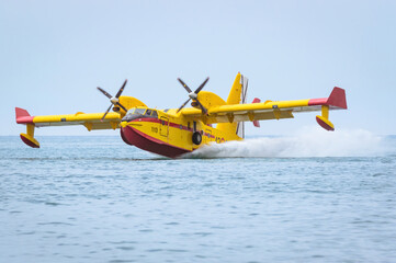 Firefighting seaplane collecting water in the sea.