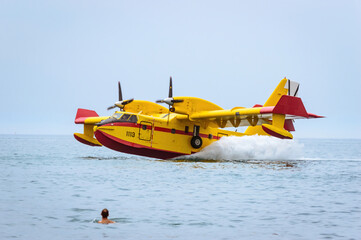 Firefighting seaplane collecting water in the sea.