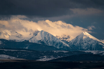 Clouds form over the Tobacco Roots Mountains during sunset in Montana